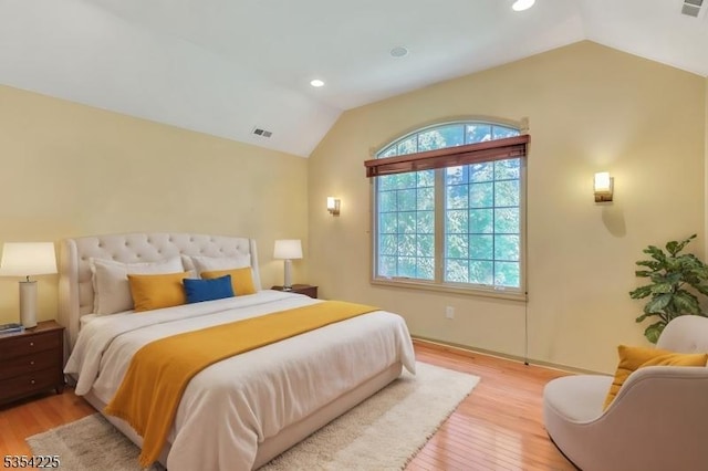 bedroom with visible vents, recessed lighting, light wood finished floors, and vaulted ceiling