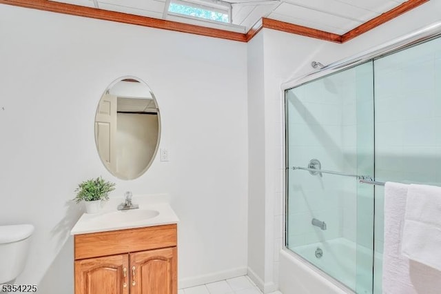 full bath with tile patterned flooring, vanity, toilet, baseboards, and bath / shower combo with glass door