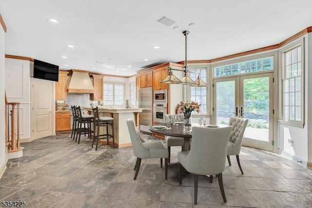 dining room featuring stone finish floor, french doors, baseboards, ornamental molding, and recessed lighting