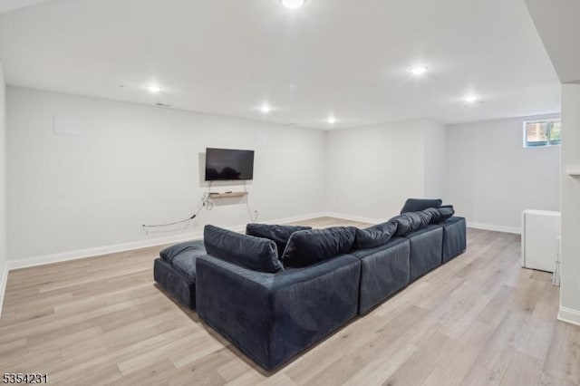 living room with recessed lighting, light wood-style flooring, and baseboards