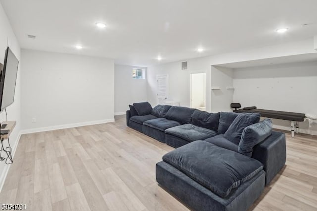 living room featuring recessed lighting, visible vents, and light wood-type flooring
