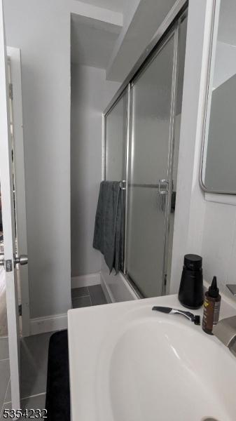 810-814 Leland Ave, Plainfield City, NJ 07062 - bathroom with tile patterned floors, a shower with shower door, and vanity