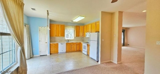 kitchen with ceiling fan, visible vents, light countertops, baseboards, and white appliances