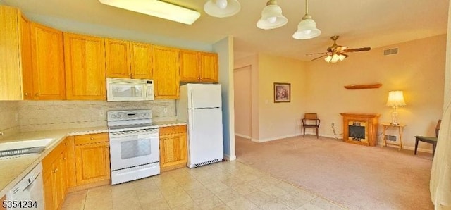 kitchen with visible vents, decorative backsplash, white appliances, light countertops, and a ceiling fan