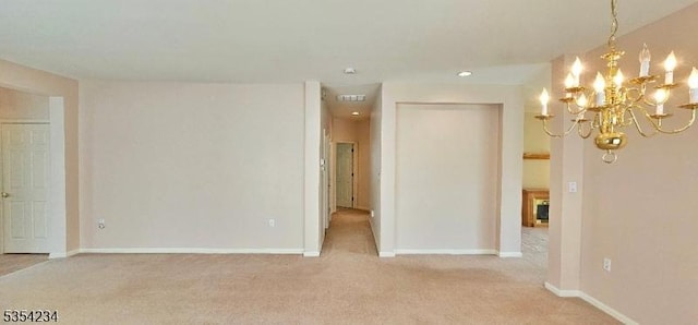 spare room with baseboards, recessed lighting, carpet, and a chandelier