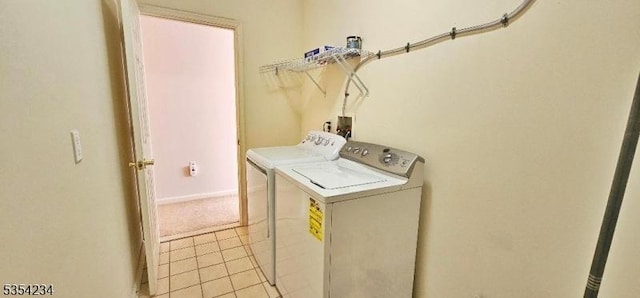 laundry room with laundry area, light tile patterned flooring, and independent washer and dryer