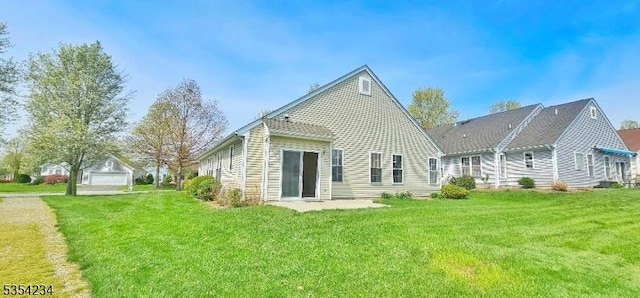 rear view of property featuring a yard