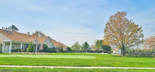 exterior space with a lawn and fence