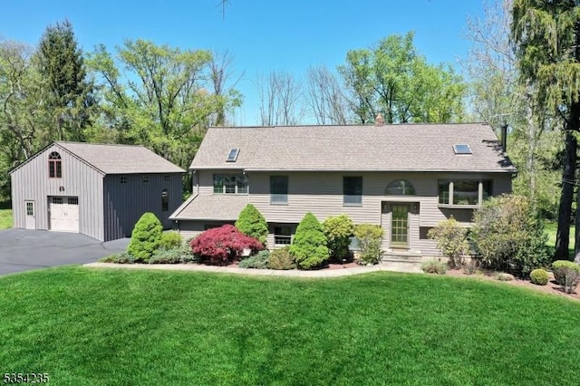 raised ranch with an outdoor structure, a chimney, a front yard, and a detached garage