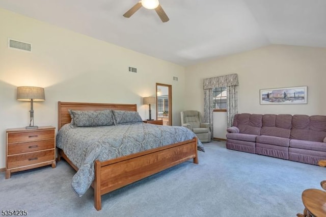 carpeted bedroom with a ceiling fan, vaulted ceiling, and visible vents