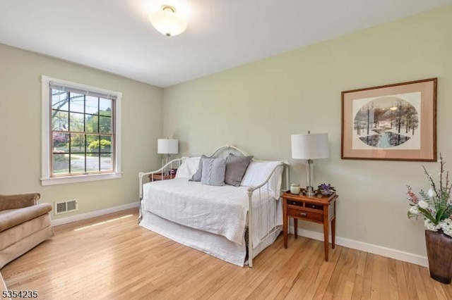 bedroom featuring light wood-style floors, baseboards, and visible vents