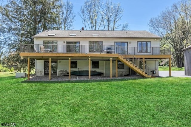 back of house featuring a yard, a deck, and stairway
