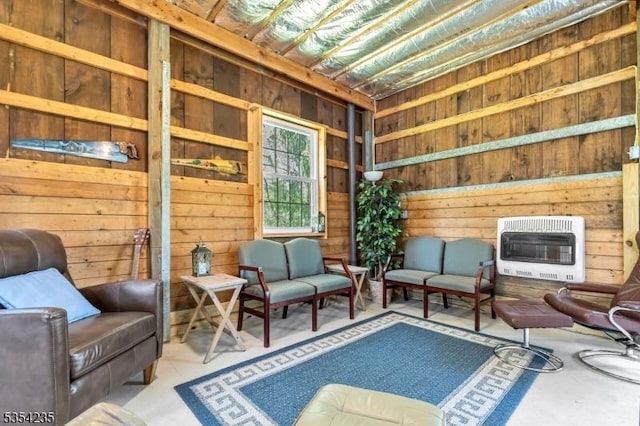 sitting room with wood walls and heating unit