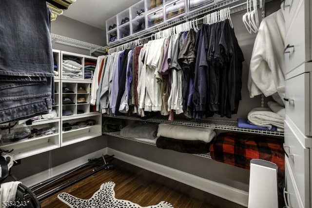 walk in closet with wood finished floors