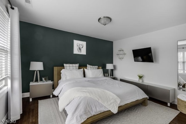 bedroom featuring baseboards and wood finished floors