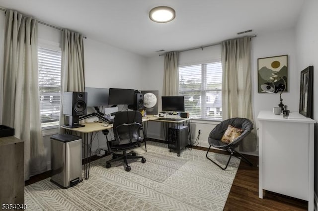 office space with light wood-type flooring and visible vents