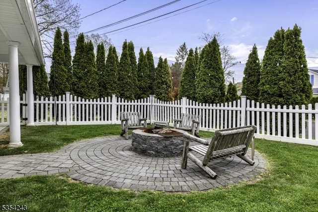 view of yard featuring a patio, fence, and an outdoor fire pit