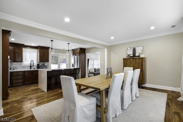 dining space featuring recessed lighting, dark wood finished floors, and ornamental molding