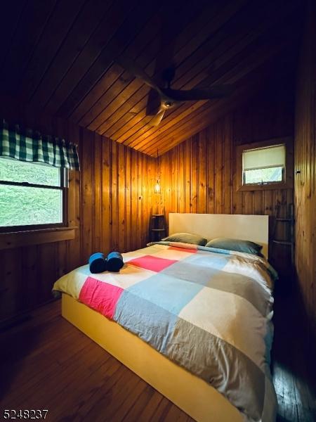 639 Canistear Rd, Vernon Twp, NJ 07422 - bedroom featuring wooden walls, wooden ceiling, and multiple windows