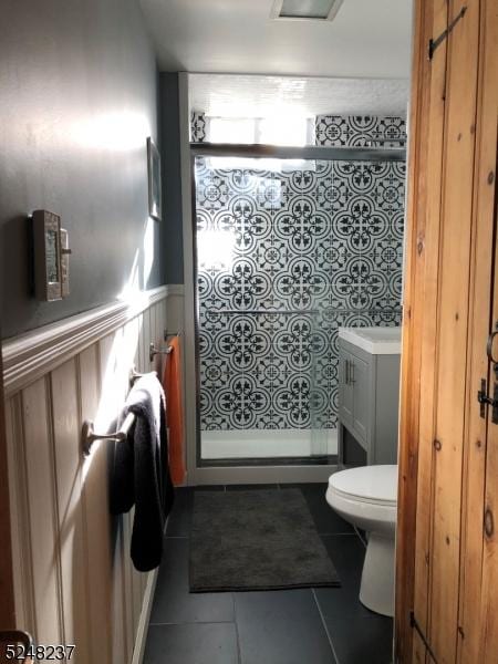639 Canistear Rd, Vernon Twp, NJ 07422 - bathroom with tile patterned flooring, vanity, wainscoting, toilet, and a stall shower