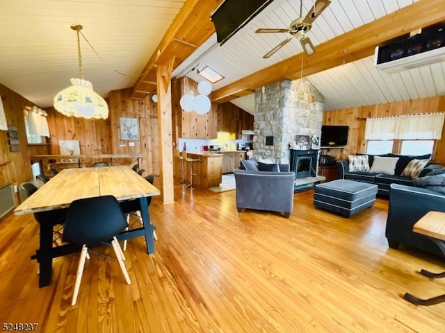 639 Canistear Rd, Vernon Twp, NJ 07422 - living area with vaulted ceiling with beams, light wood-type flooring, wood walls, and ceiling fan