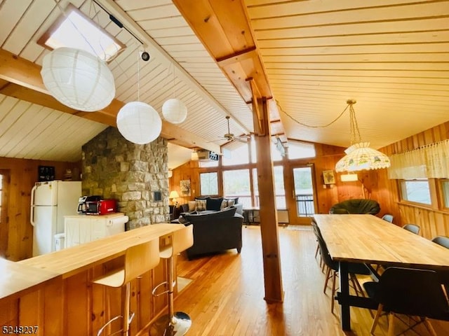 639 Canistear Rd, Vernon Twp, NJ 07422 - dining area featuring wood walls, lofted ceiling with beams, wooden ceiling, and light wood-type flooring