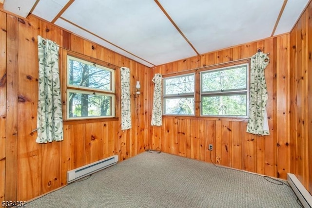 spare room with a baseboard radiator, baseboard heating, carpet flooring, and a wealth of natural light