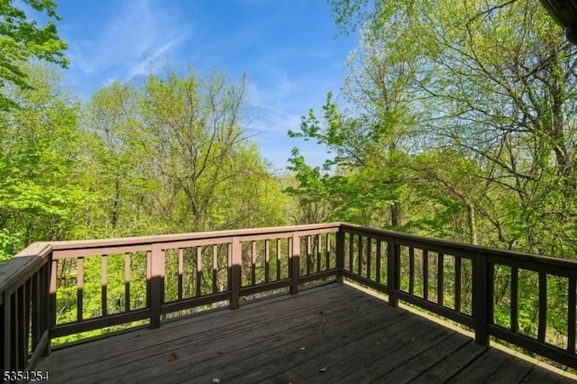 wooden terrace with a view of trees