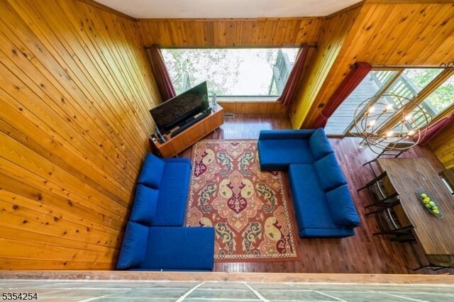 living room featuring wooden walls and a healthy amount of sunlight