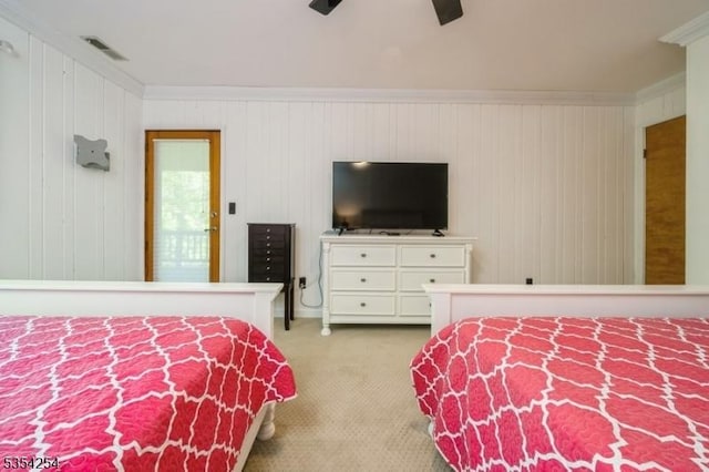 bedroom featuring visible vents, ornamental molding, carpet, and a ceiling fan