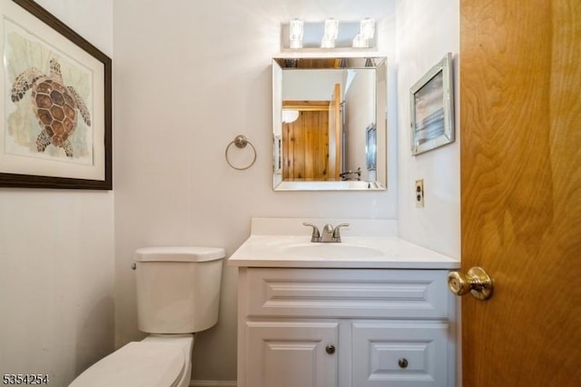 half bathroom with toilet and vanity