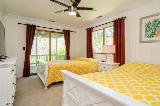 bedroom featuring crown molding, access to exterior, multiple windows, and light carpet
