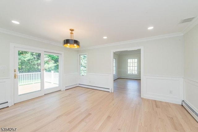 empty room featuring plenty of natural light, a baseboard radiator, a decorative wall, and visible vents
