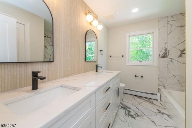 bathroom with a sink, marble finish floor, a baseboard heating unit, and toilet