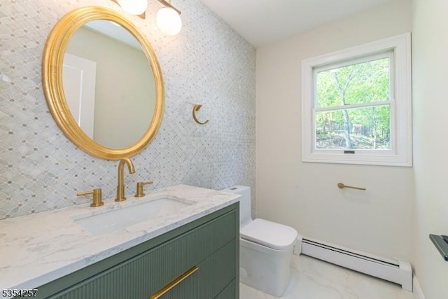 bathroom with vanity, toilet, marble finish floor, and a baseboard radiator
