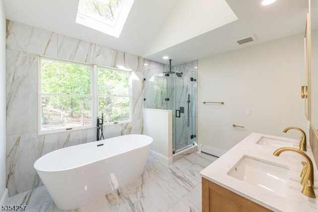 bathroom featuring a freestanding tub, visible vents, a marble finish shower, and a sink