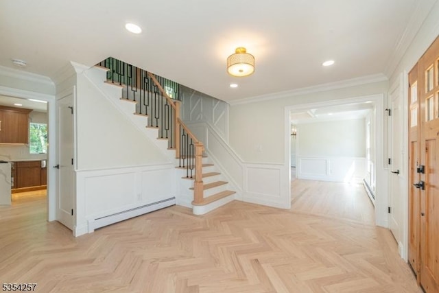 interior space with a decorative wall, crown molding, a wainscoted wall, and a baseboard radiator