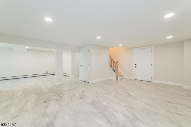 finished basement featuring recessed lighting, baseboard heating, and stairway