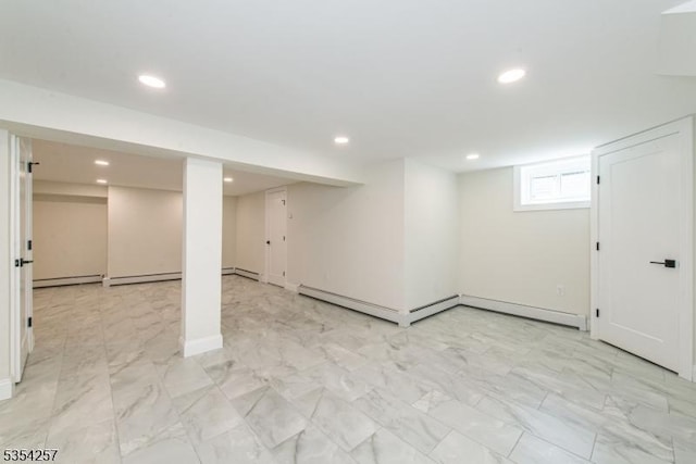 basement with a baseboard radiator, recessed lighting, and marble finish floor