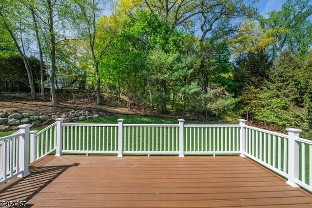 wooden terrace with a lawn