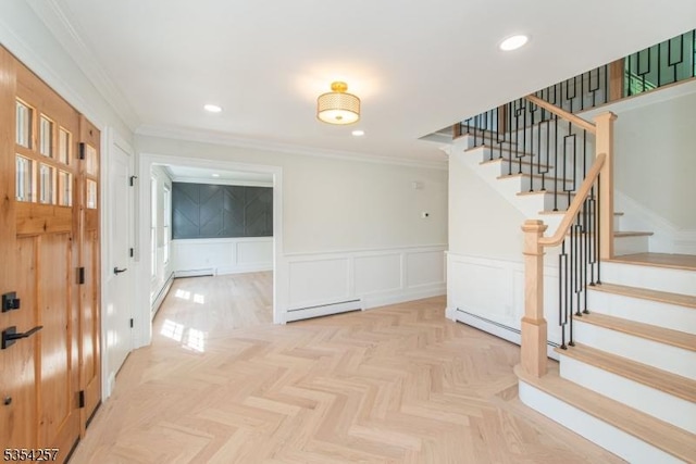 interior space featuring ornamental molding, stairs, a decorative wall, and a baseboard heating unit