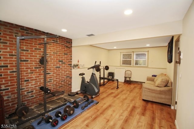 exercise room with baseboards, recessed lighting, wood finished floors, and visible vents