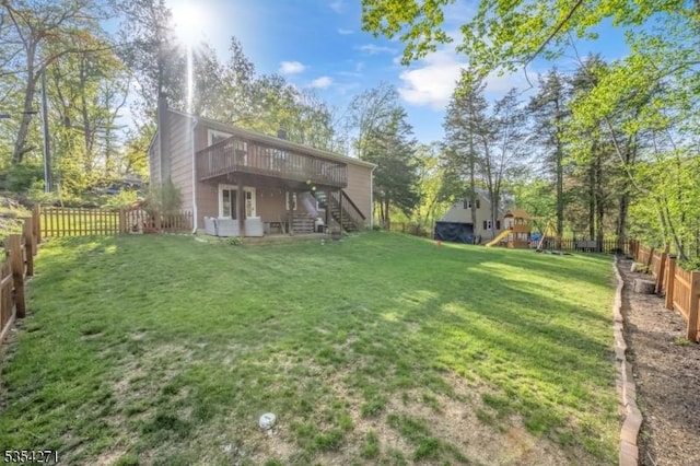 12 Fox Ledge Dr, Vernon Twp, NJ 07418 - view of yard featuring a wooden deck, a fenced backyard, a playground, and stairs