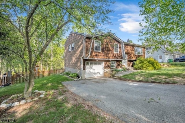 12 Fox Ledge Dr, Vernon Twp, NJ 07418 - view of front of property with an attached garage, fence, driveway, and a front yard