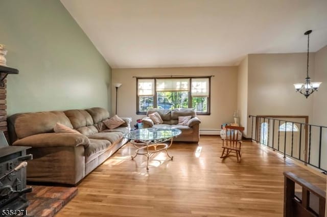 12 Fox Ledge Dr, Vernon Twp, NJ 07418 - living room featuring an inviting chandelier, wood finished floors, and lofted ceiling