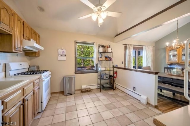 12 Fox Ledge Dr, Vernon Twp, NJ 07418 - kitchen featuring white gas range oven, baseboard heating, ceiling fan with notable chandelier, under cabinet range hood, and vaulted ceiling