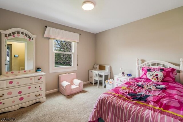 carpeted bedroom featuring baseboards