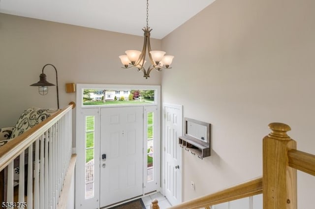 tiled entryway featuring a chandelier