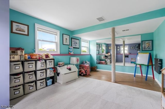 game room featuring carpet floors, plenty of natural light, and visible vents