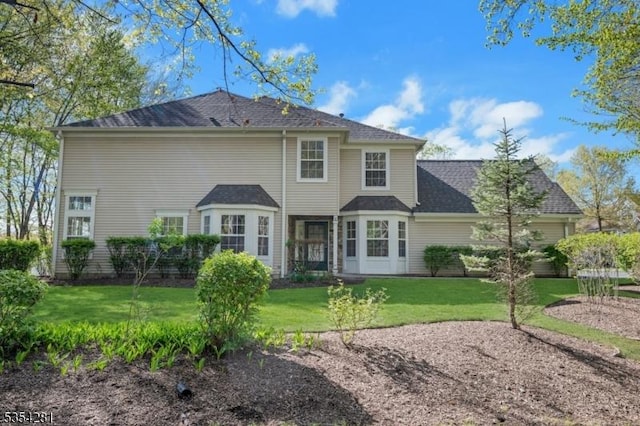 rear view of house with a yard